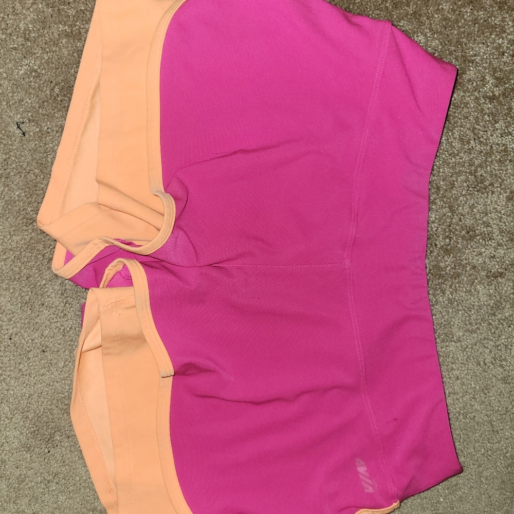 Pink shorts with orange compression shorts under